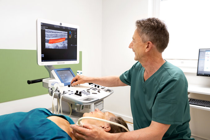 Ein Arzt untersucht eine Patientin mittes Ultraschall.